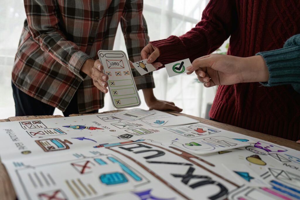 The web designer team is helping to design applications for mobile phones. UX UI designer concept